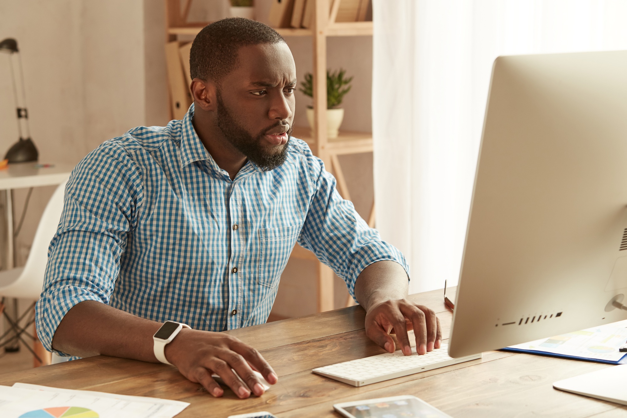 Concentrated at work. Afro american businessman working remotely. Focused young afro american man in