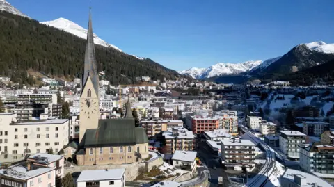 Reuters A view of St Johann church and the town of Davos ahead of the annual meeting of the World Economic Forum. There is a light covering of snow across the town and mountains can be seen in the background