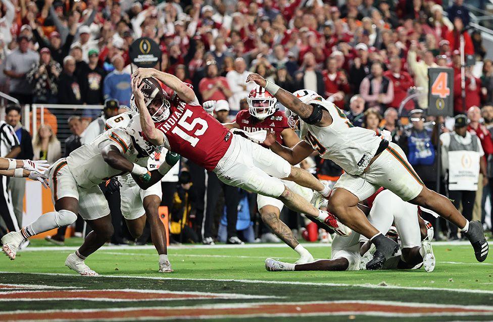 The Indiana Hoosiers' Fernando Mendoza dives over the line for a fourth-quarter touchdown during their win over the Miami Hurricanes in the College Football Play-off National Championship game in Florida. Photo by Carmen Mandato