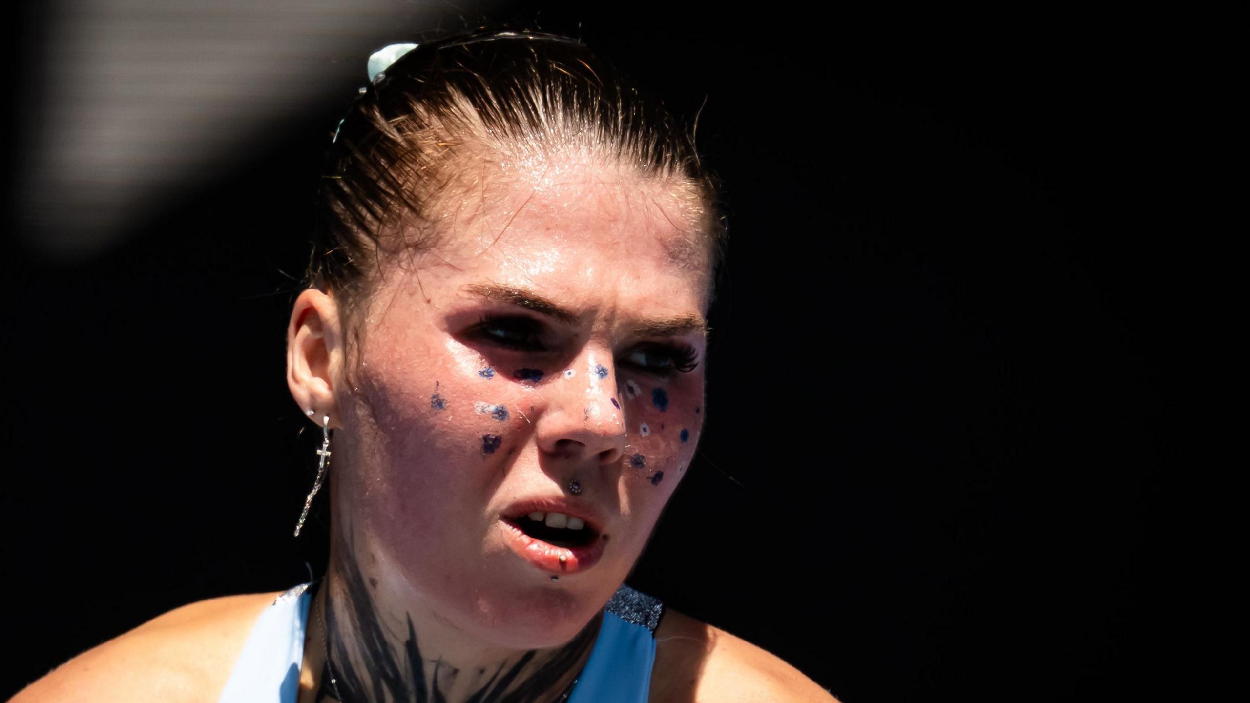 Oleksandra Oliynykova hits a serve at the 2026 Australian Open