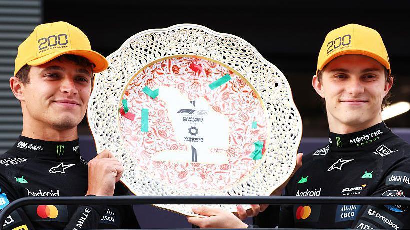 Lando Norris and Oscar Piastri holding the Hungarian Grand Prix constructors' trophy