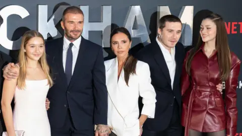 Getty Images The Beckhams and Brooklyn and Nicola are pictured on a red carpet
