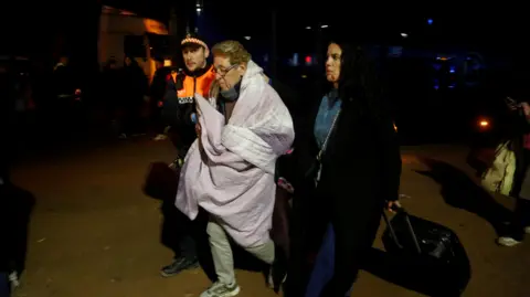 Reuters A person affected by a deadly train derailment is transferred for treatment to the Caseta Municipal in the town of Adamuz, after a high-speed train derailed.