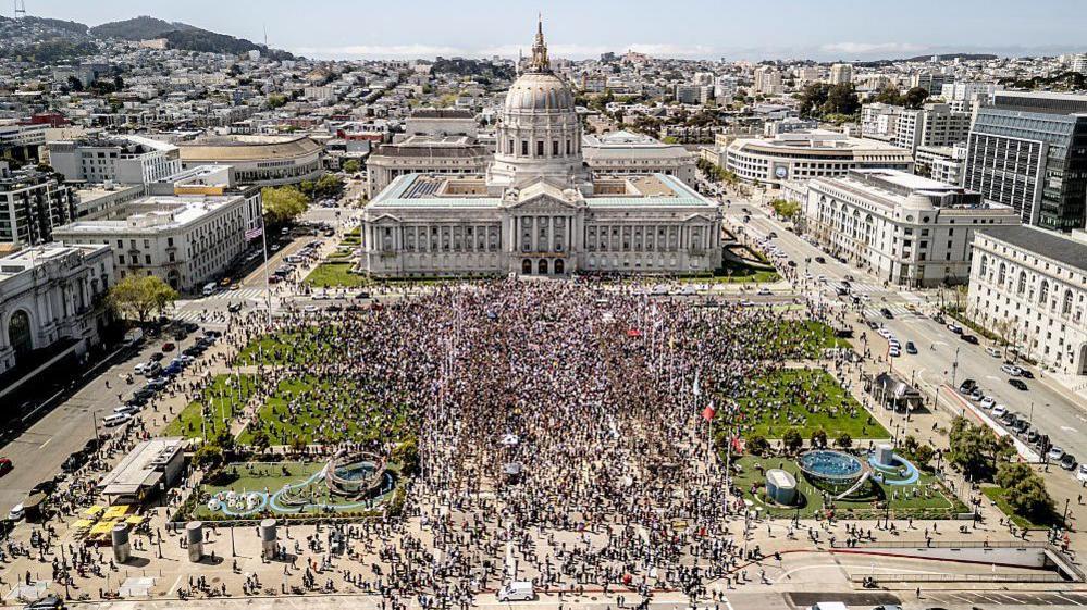 Crowds gather outside City Hall on the Civic Center Plaza in San Francisco