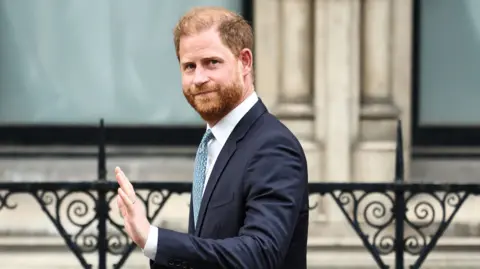 Getty Images Prince Harry, Duke of Sussex waves as he leaves the High Court, in central London, on April 8, 2025 after an hearing about a government decision to downgrade his personal security during visits in Britain.