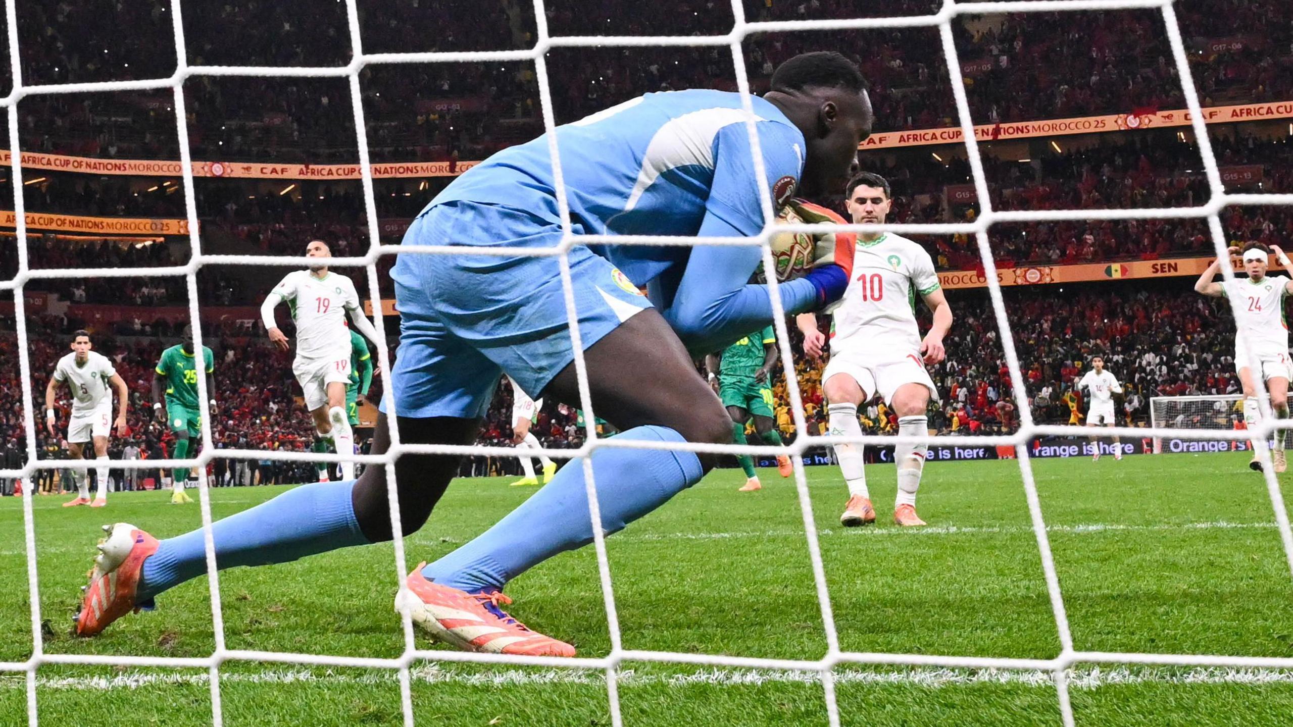 Senegal goalkeeper Eduoard Mendy catches Morocco's Brahim Diaz's Panenka penalty in Africa Cup of Nations final