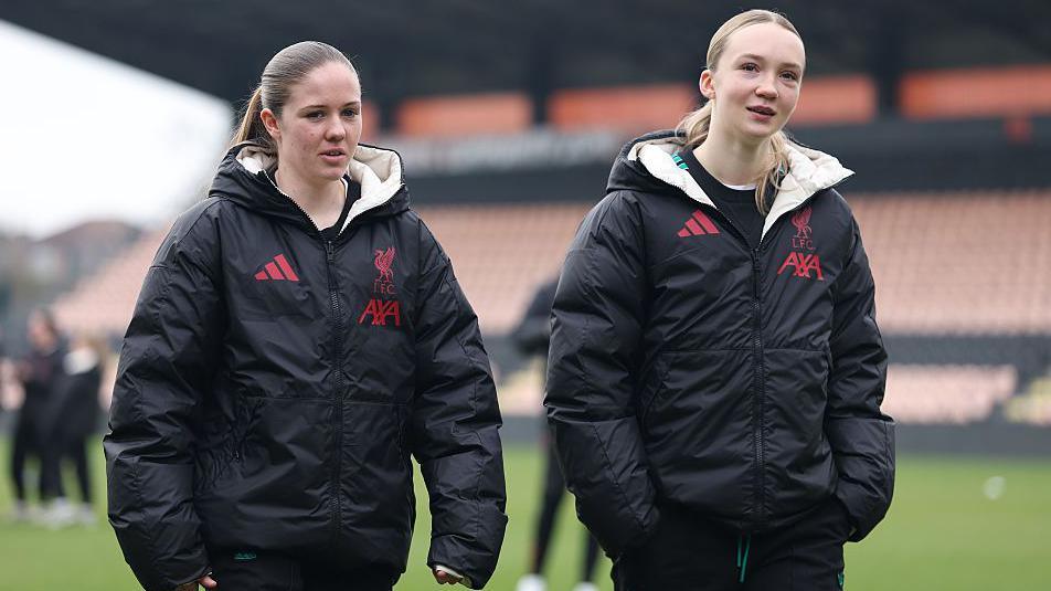 Maizie Trueman and Neve McDonald looks on during the pitch inspection