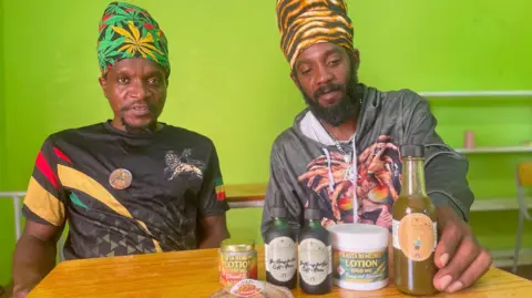 Gemma Handy High Priest Selah of Antigua&rsquo;s Nyabinghi community, left, and fellow Rastafarian Andre Solomon, with some of the the community's cannabis products