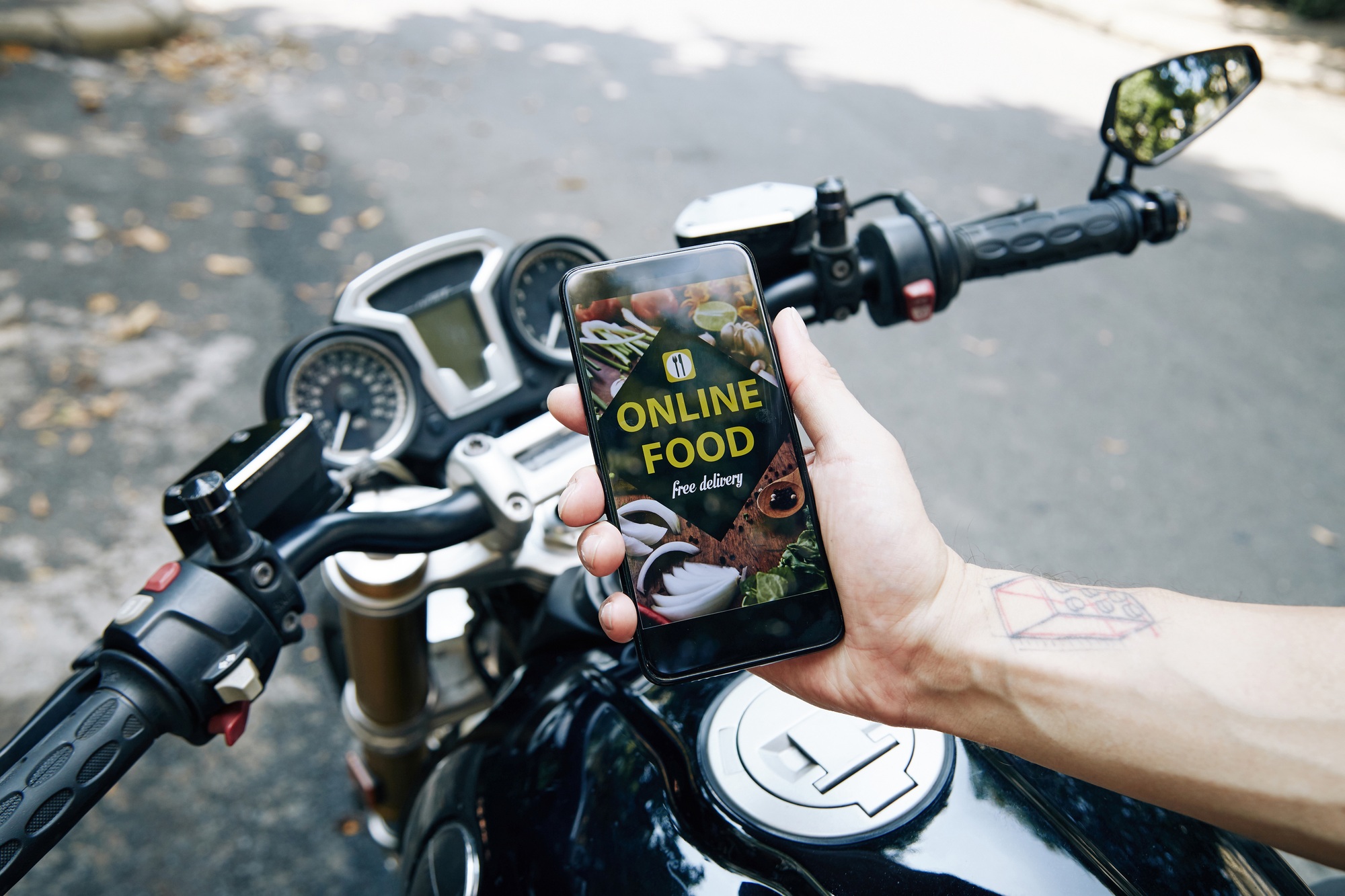 Motorcyclist Showing Food Delivery App