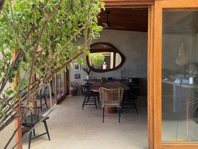 Image may contain: Floor, Indoors, Interior Design, Flooring, Plant, Chair, Furniture, Person, Art, Painting, and Clothing