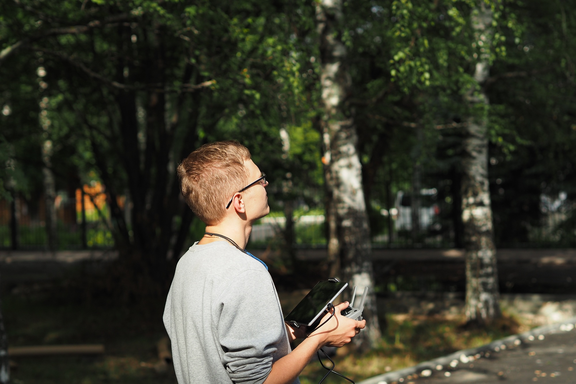 Pilot drone. A young man controls a drone. Photo and video aerial photography.