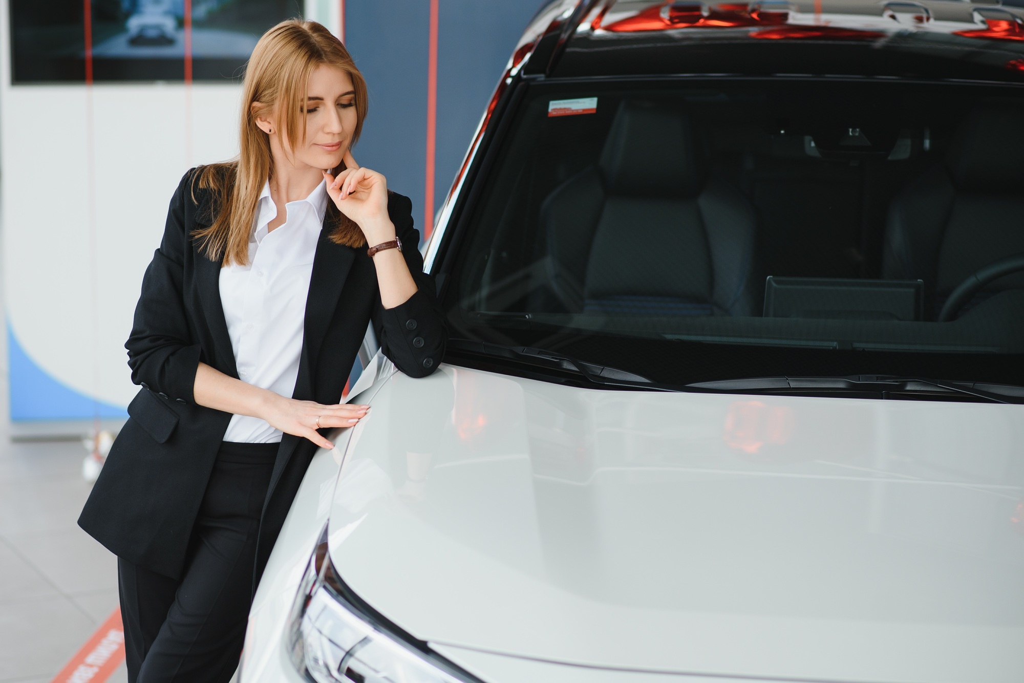 Salesperson selling cars at car dealership.