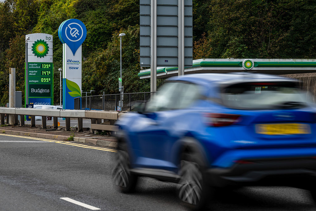 Fuel prices and EV charging are displayed by the roadside at a BP forecourt in Dover, UK, on Friday, Oct. 17, 2025