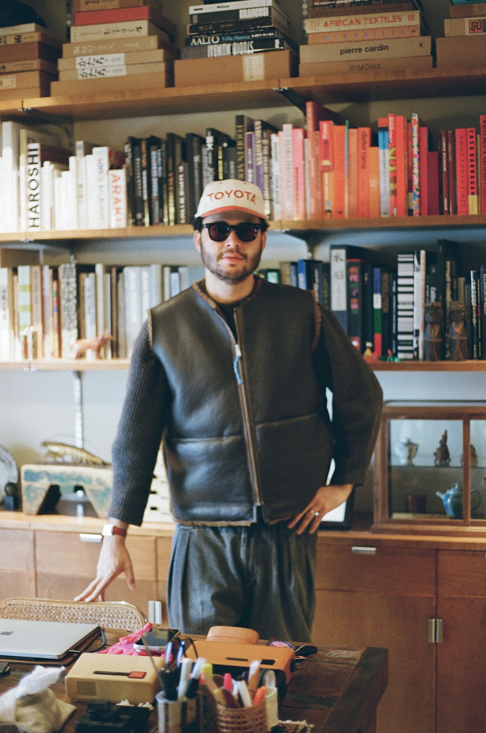 Image may contain Clothing Coat Jacket Book Indoors Library Publication Face Head Person Photography and Portrait