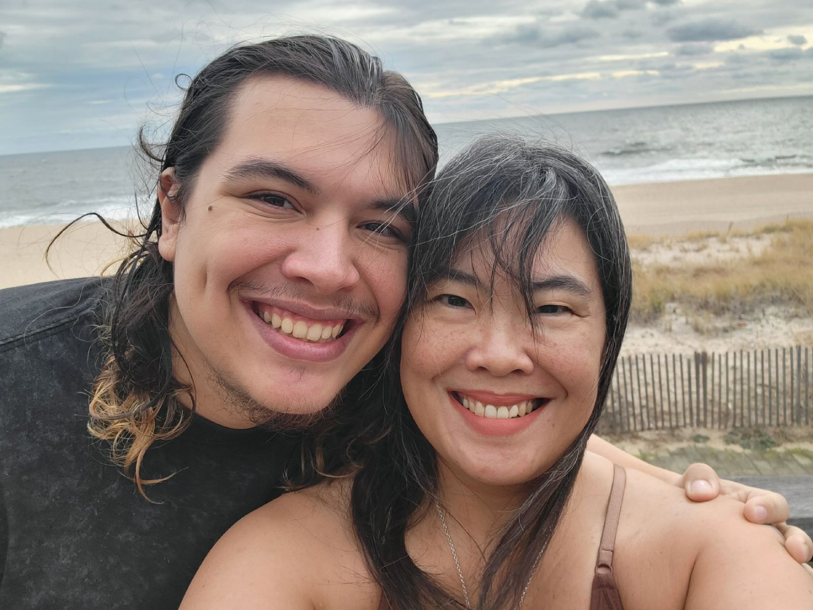 Image may contain Face Head Person Photography Portrait Happy Smile Beach Coast Nature Outdoors and Sea
