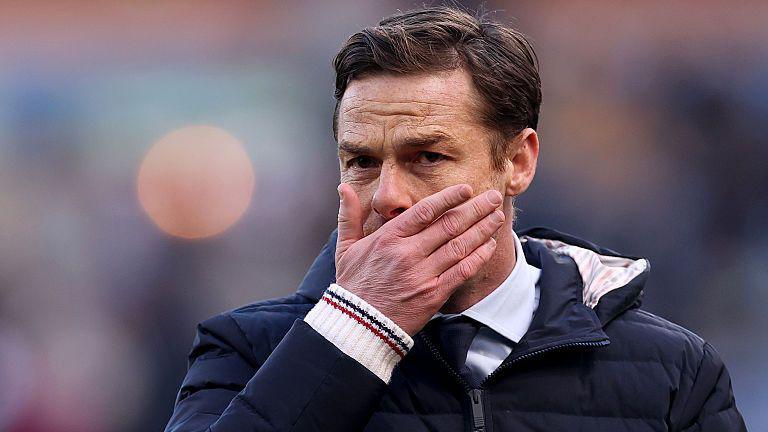 Scott Parker holds his face
