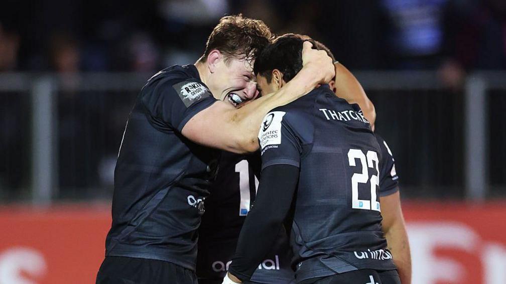 Ted Hill (left) grabs team-mate Santiago Carreras around the back of the neck and holds their foreheads together in celebration while on the pitch during a match