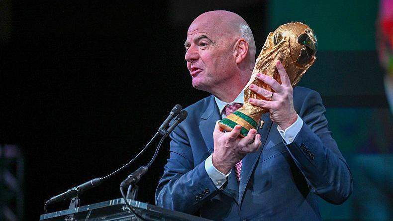 Gianni Infantino holds the World Cup trophy