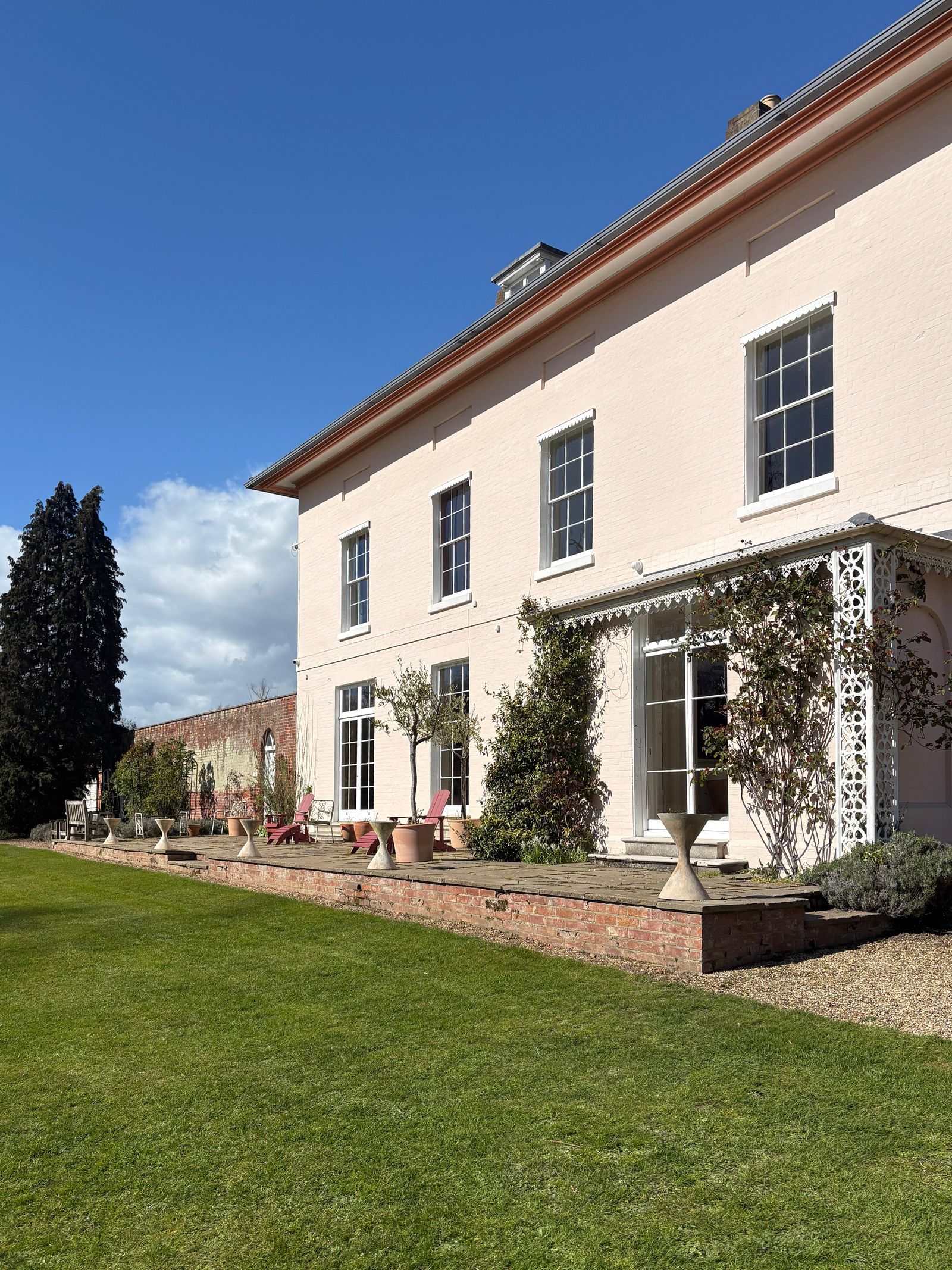 Image may contain Grass Plant Architecture Building Housing House Villa Portico Chair Furniture and Person