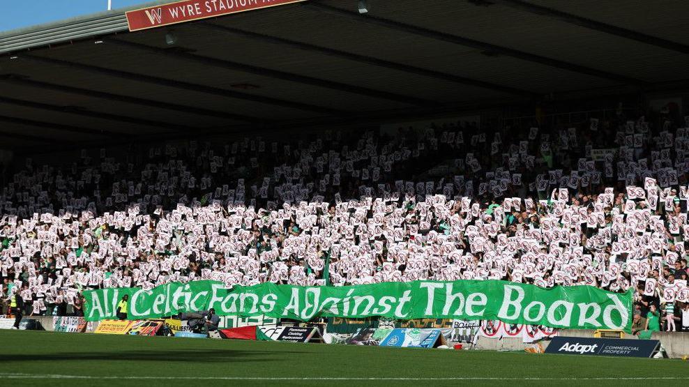 Celtic fans protest against the board during a Premier Sports Cup quarter-final match at Partick Thistle