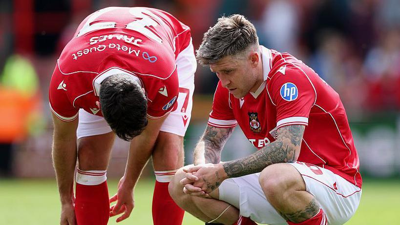Wrexham duo Matty James (left) and Josh Windass (right) look dejected