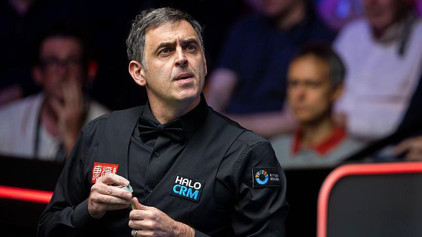 Ronnie O'Sullivan prepares to play a shot during his first-round match at the 2026 World Snooker Championship