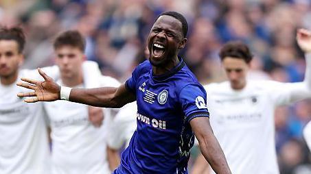 Mani Dieseruvwe celebrates Rochdale's penalty shootout win over Boreham Wood