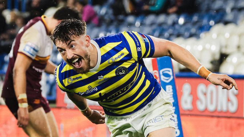 Warrington Wolves winger Matty Ashton celebrating scoring a try against Huddersfield