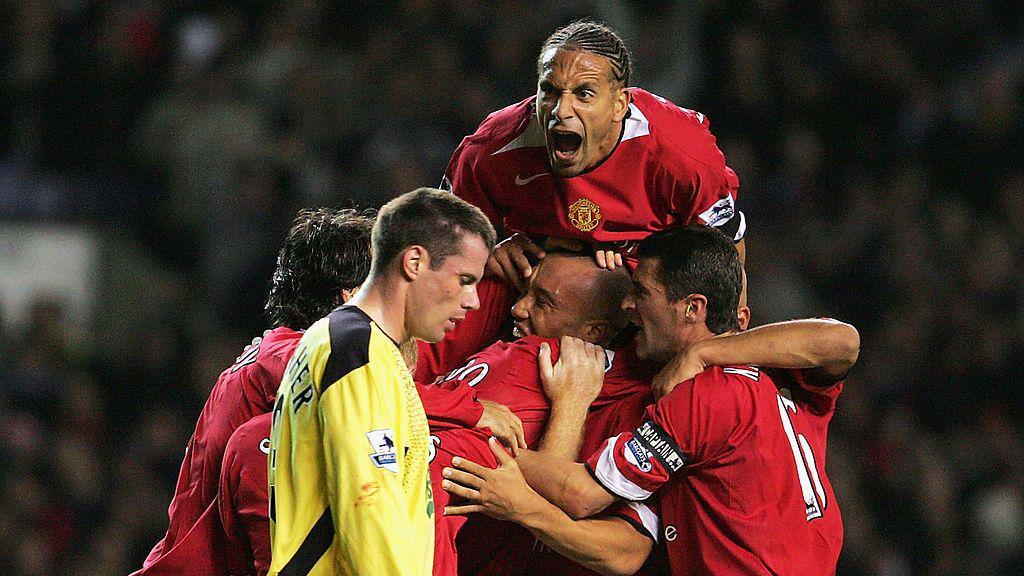 Manchester United players celebrate next to Jamie Carragher