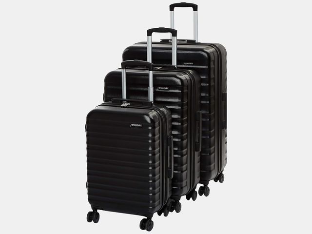 3 black rolling suitcases
