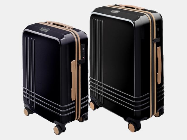 two tan and black rolling suitcases