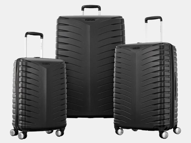 three black rolling suitcases