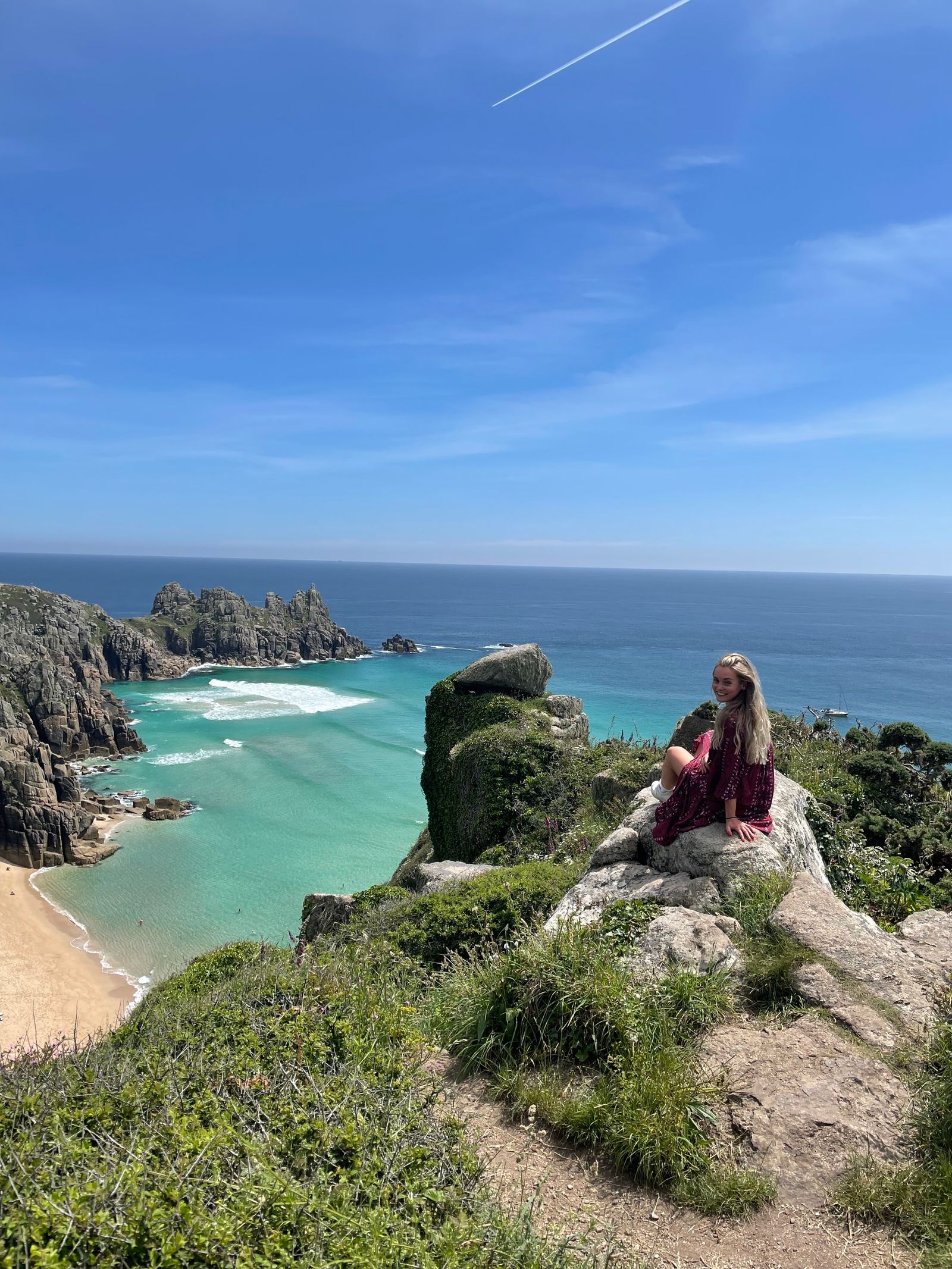 Image may contain Nature Outdoors Sea Water Sky Horizon Coast Shoreline Child Person Sitting Fun and Vacation