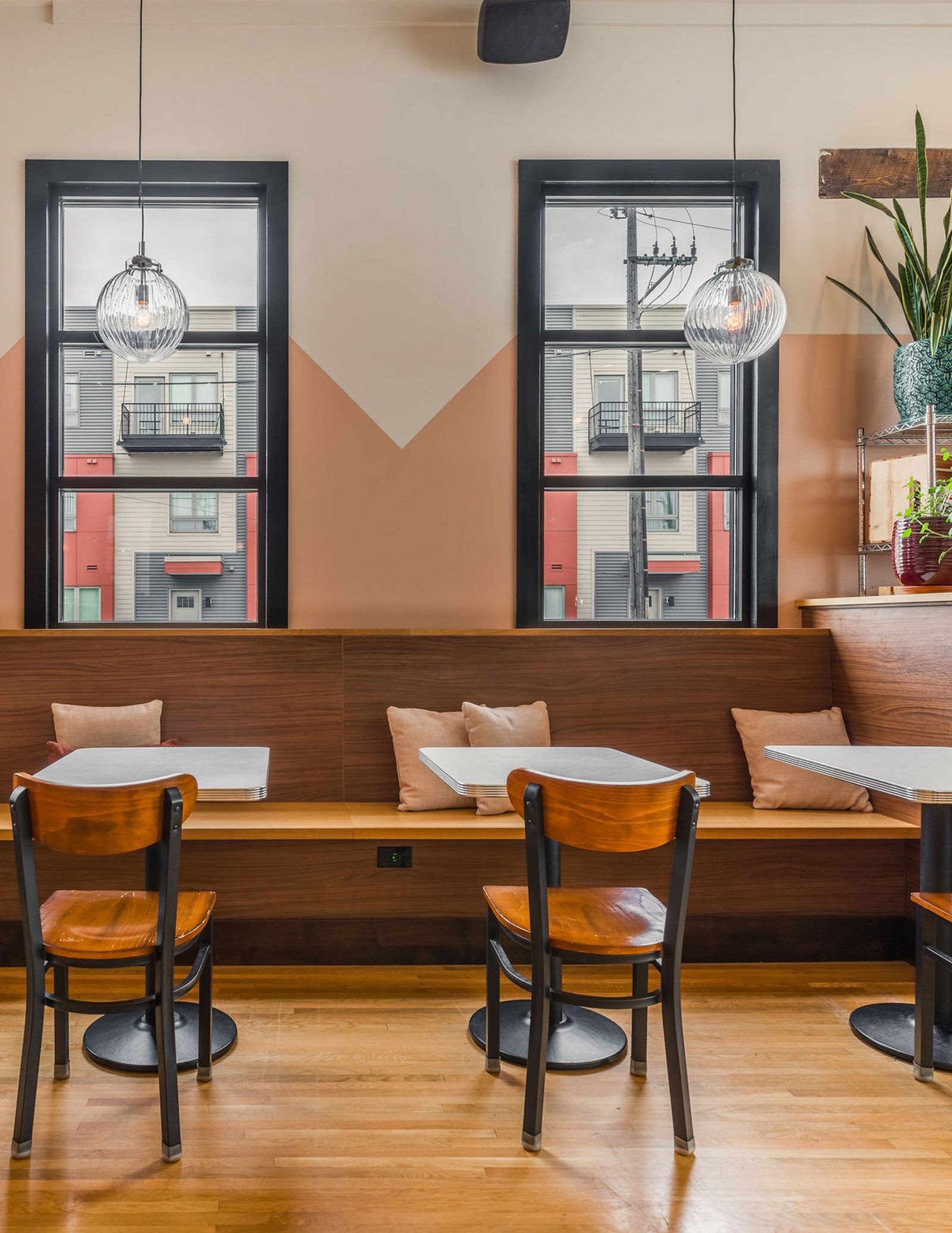 Image may contain Indoors Interior Design Wood Restaurant Cafe Dining Table Furniture Table Chair and Architecture