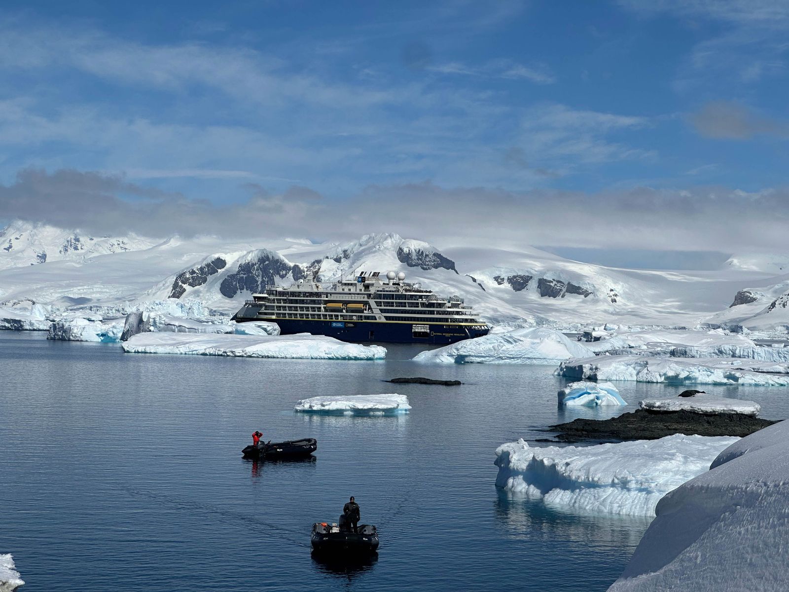 Image may contain Ice Boat Transportation Vehicle Outdoors Nature Person Glacier Mountain and Ship