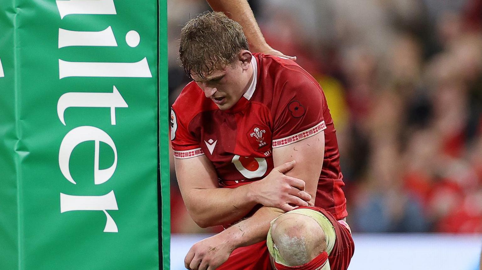 Jac Morgan cradles his injured shoulder
