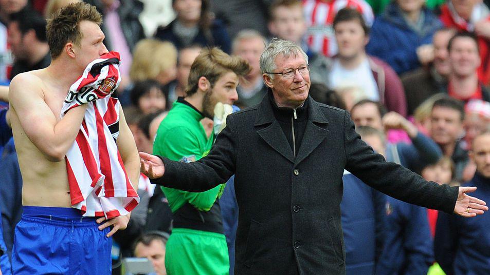 Phil Jones and Sir Alex Ferguson look on in despair