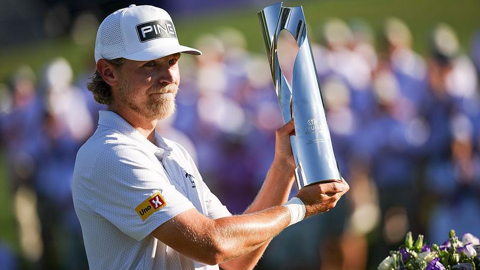 Kristoffer Reitan holding his trophy aloft after winning the Truist Championship in 2026