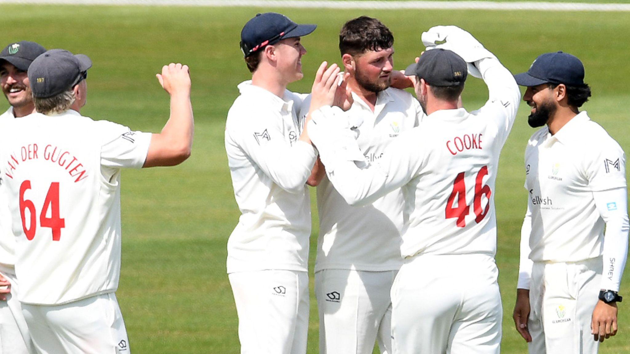 Tom Norton is congratulated by Glamorgan team-mates including Timm van der Gugten (left) and wicketkeeper Chris Cooke