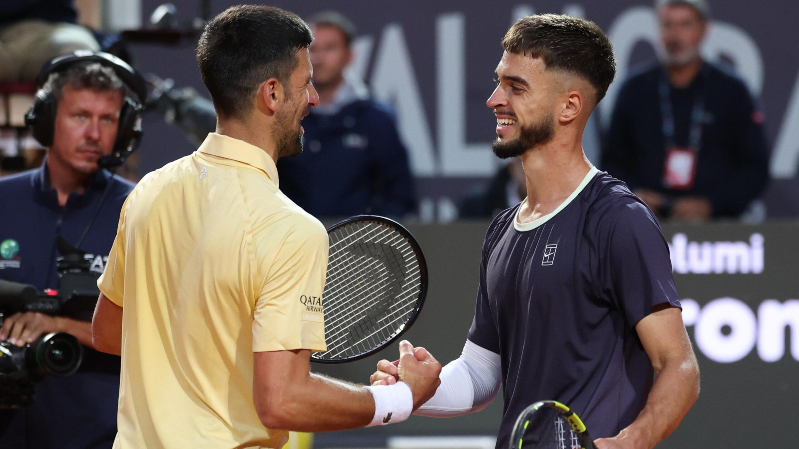 Novak Djokovic shakes hands with Dino Prizmic after the match