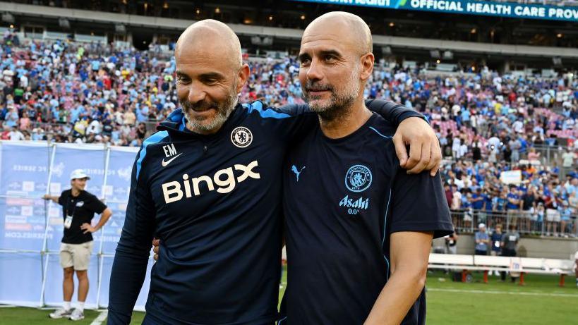 Enzo Maresca and Pep Guardiola embrace while managing opposing teams in pre-season for Chelsea and Man City
