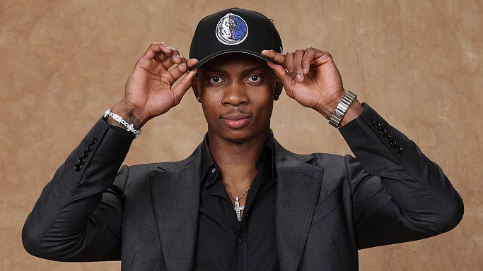 Tobi Lawal poses for a photo after being selected in the 2026 NBA Draft