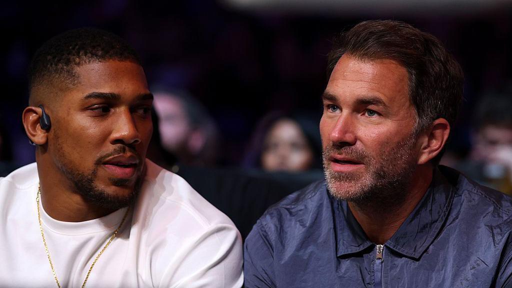 Eddie Hearn and Anthony Joshua in conversation at ringside