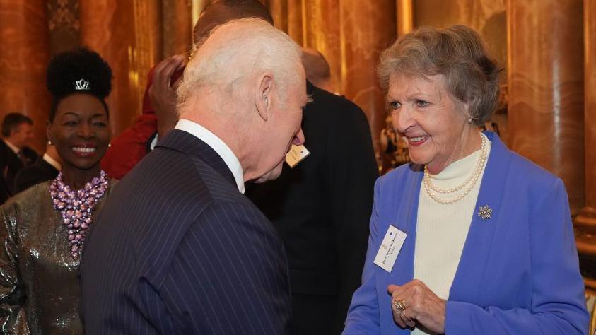 Penelope Keith is shown in conversation with King Charles at a reception in 2024