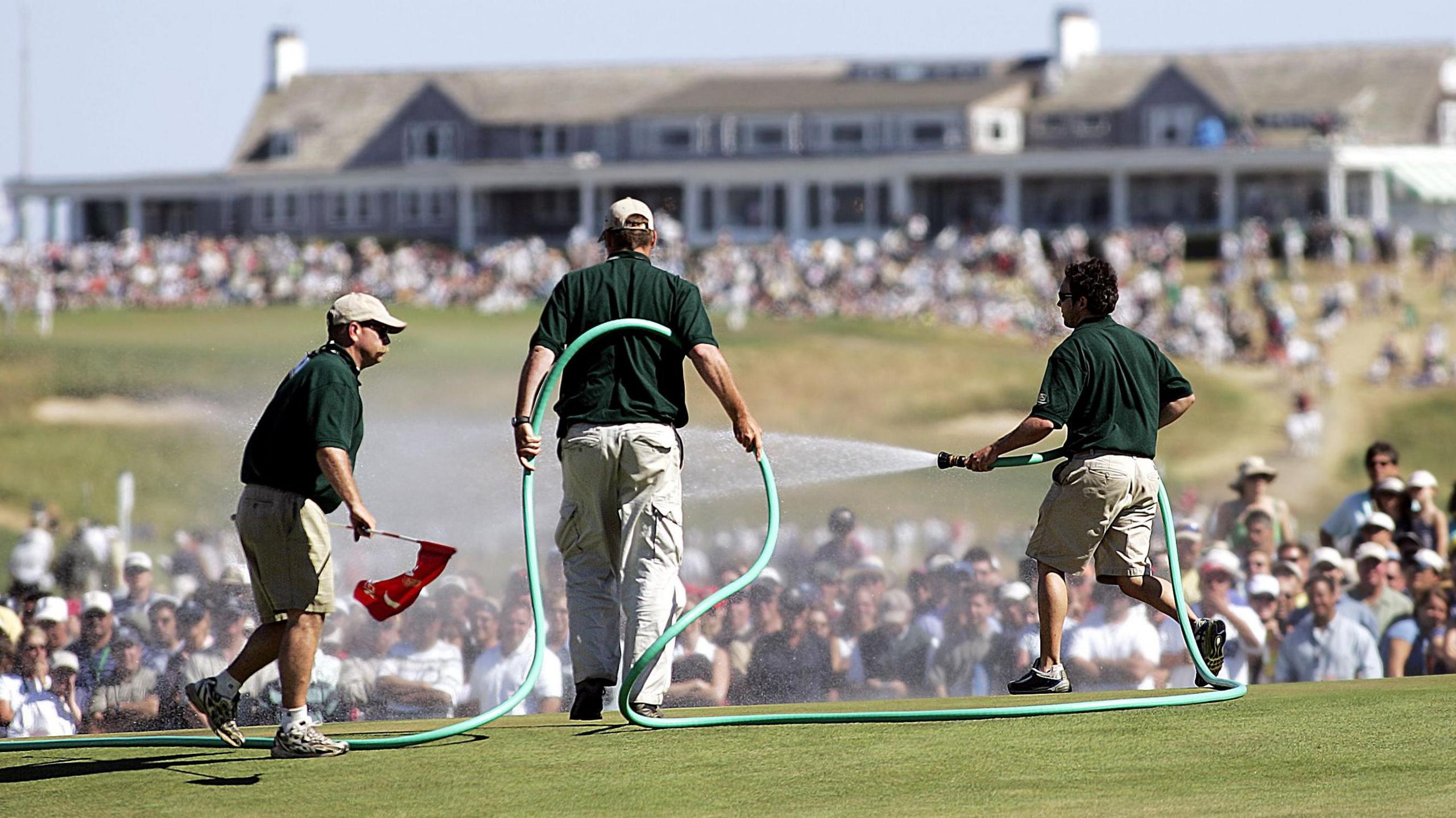 Greenstaff watering the par-three seventh green during the final round of the 2004 US Open at Shinnecock Hills, New York.