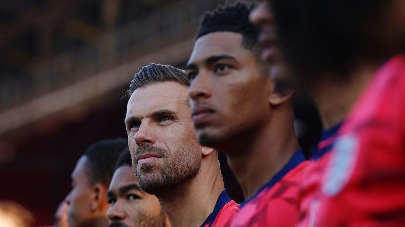 Jordan Henderson and Jude Bellingham in red England outfits