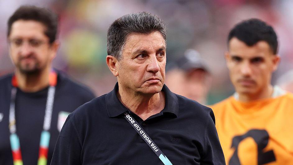 Amir Ghalenoei, wearing a black jumper, frowns