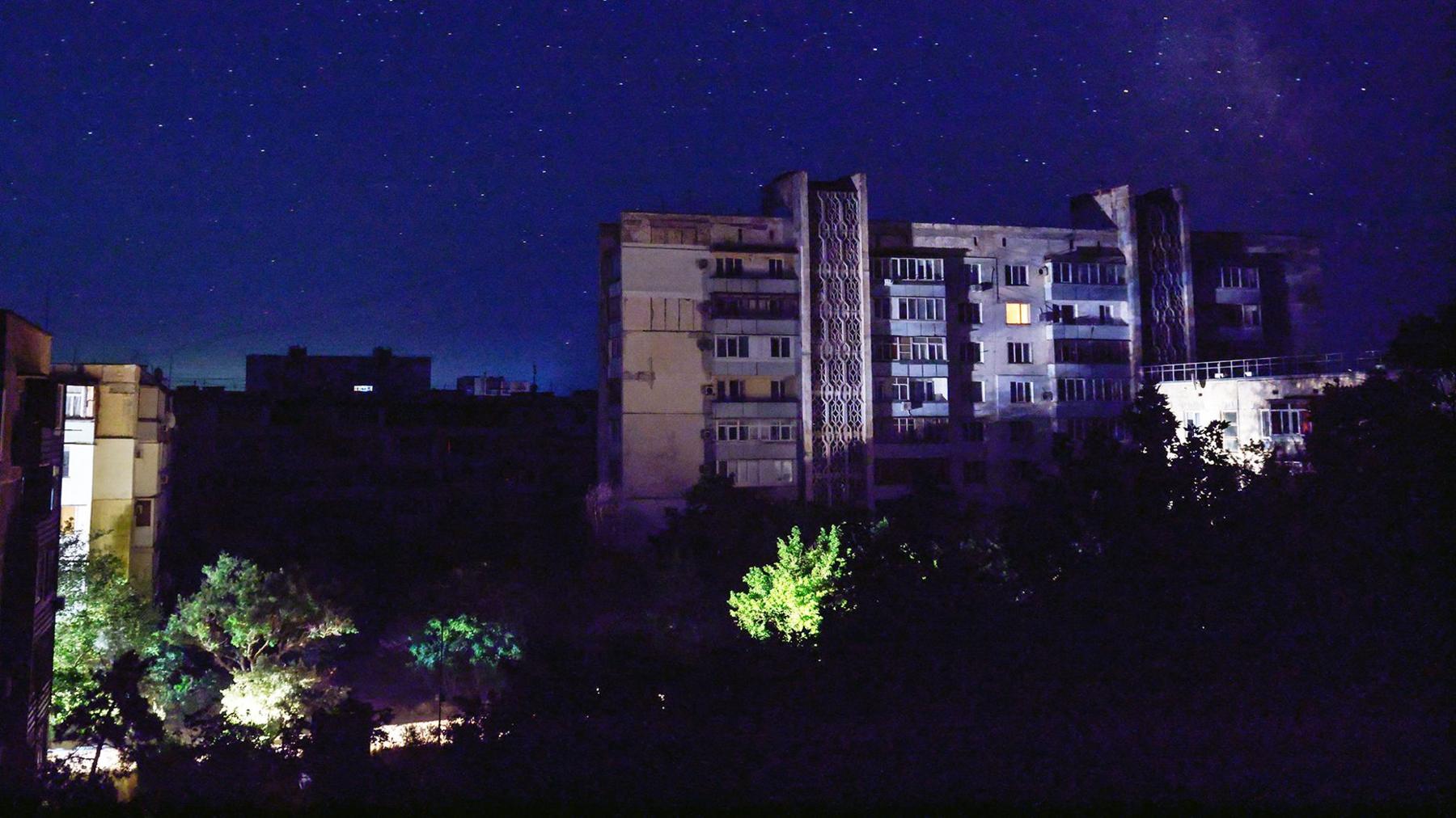 Residential buildings at night during a temporary power outage, which local authorities said was caused by technological disturbances in the peninsula’s energy grid