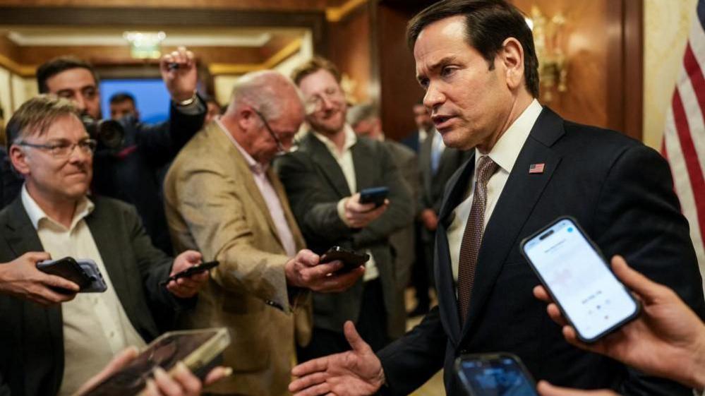Marco Rubio surrounded by reporters in Kuwait