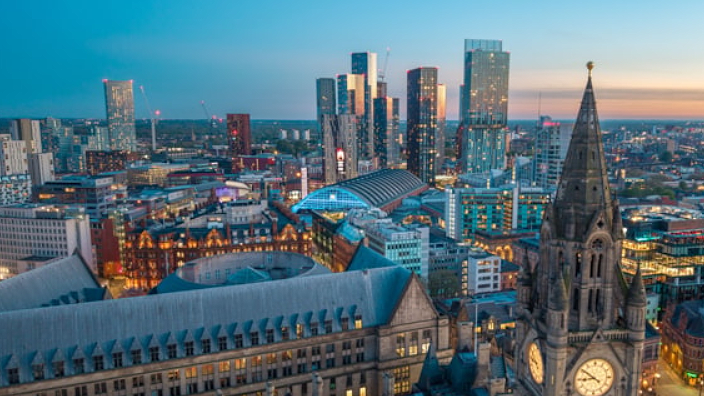 An aerial view of the Manchester city centre skyline during the day.